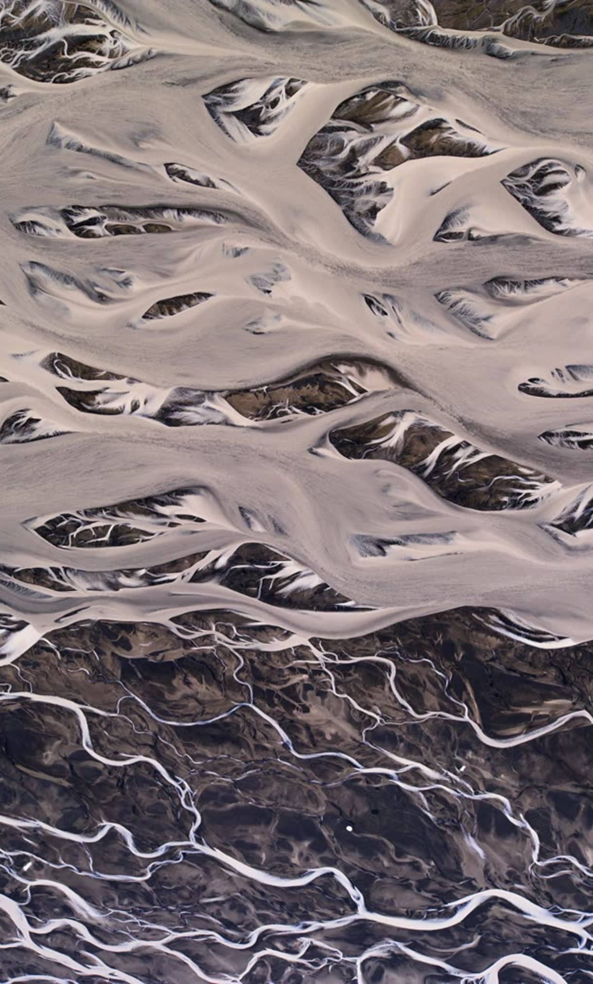 An Icelandic river delta filling a Mac screen